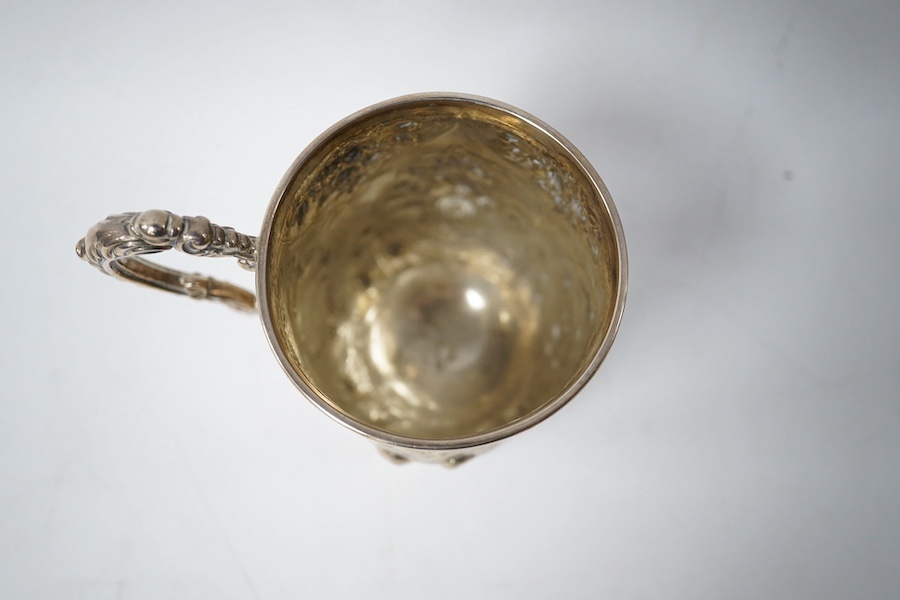 A Victorian embossed silver christening mug, George Adams, London, 1868, with later engraved monogram with date, 10.5cm, 4.5oz. Condition - fair to good